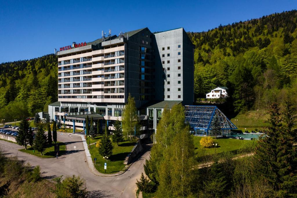 a hotel in the mountains with a building at Hotel Mara in Sinaia