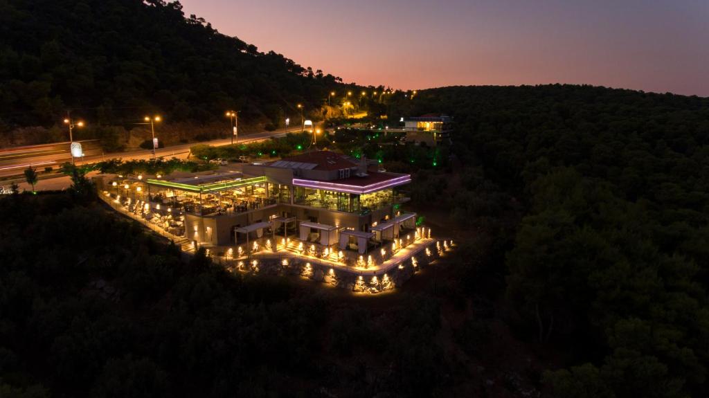 an aerial view of a building with lights at night at STORK Design Suites in Ancient Epidauros