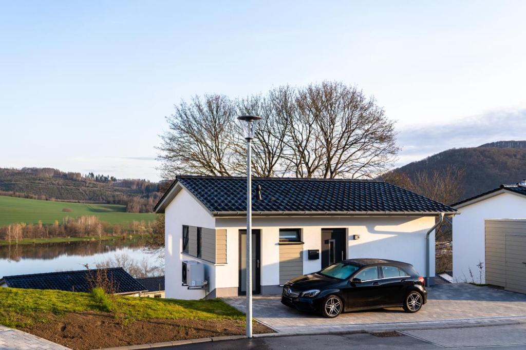 a black car parked in front of a house at Ferienhaus SONNENWEG 16 in Heringhausen