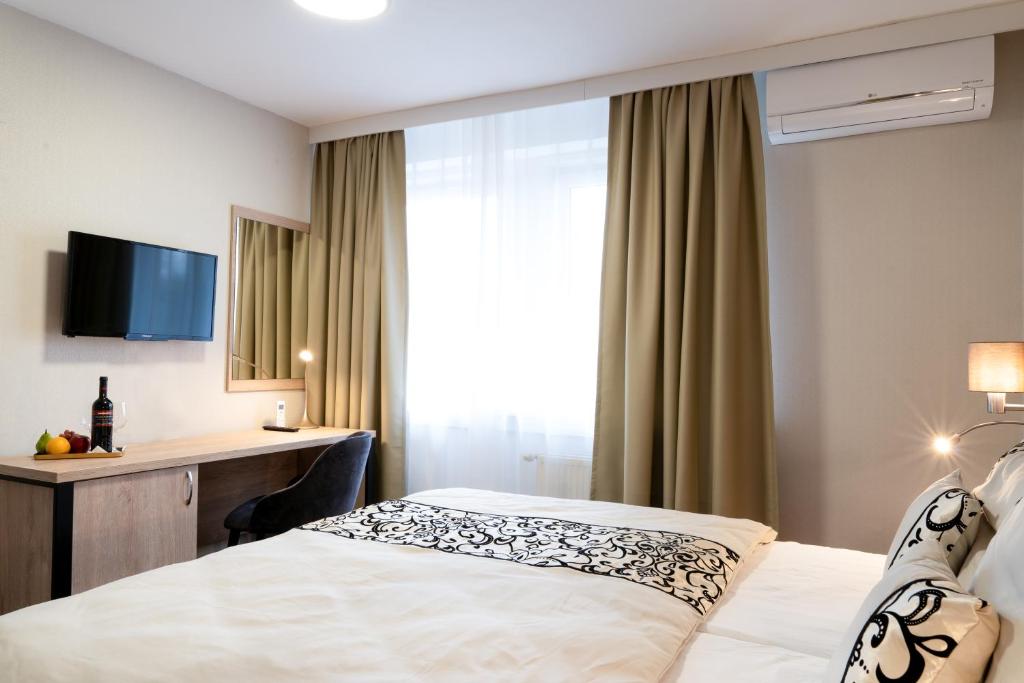 Postel nebo postele na pokoji v ubytování Hotel Karolina