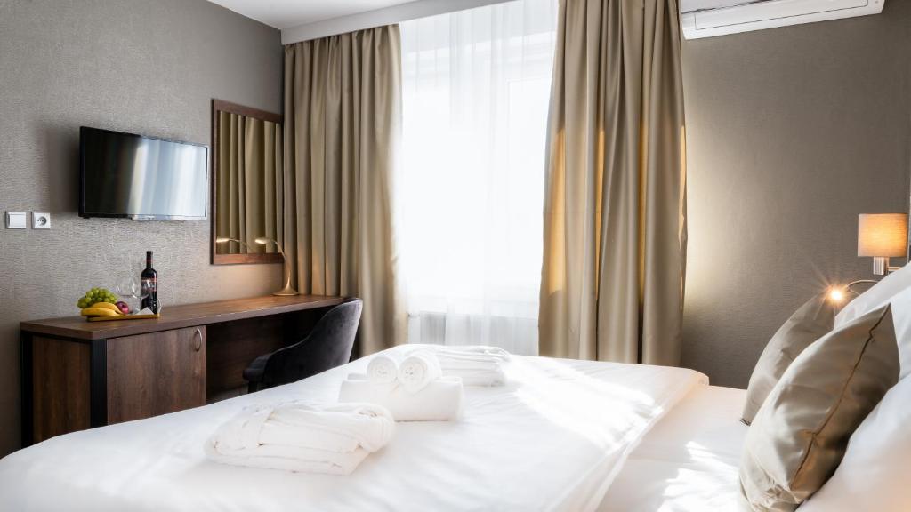 Postel nebo postele na pokoji v ubytování Hotel Karolina