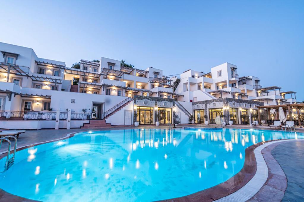 a large swimming pool in front of a building at Elementa Boutique Hotel - Adults Friendly in Yalıkavak