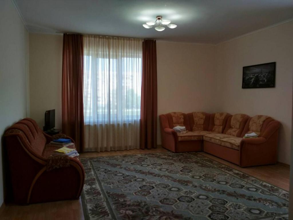 a living room with a couch and a window at Просторная квартира с видом на горы in Mukacheve