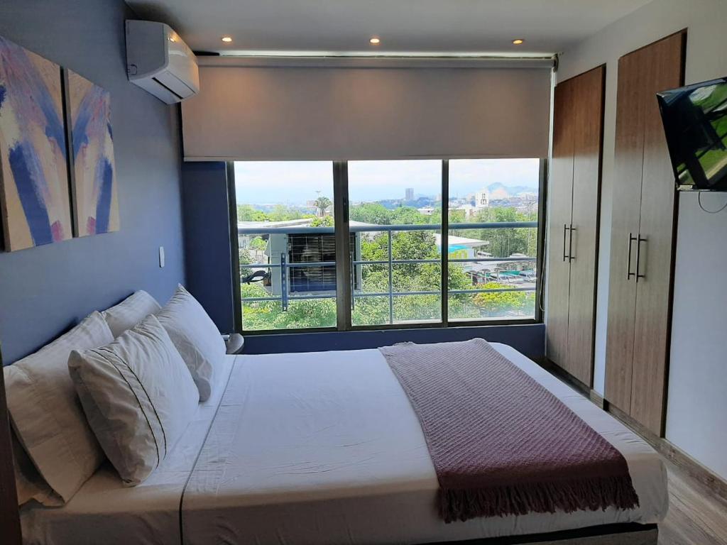 Voodi või voodid majutusasutuse Santorini Apartamentos Amoblados toas