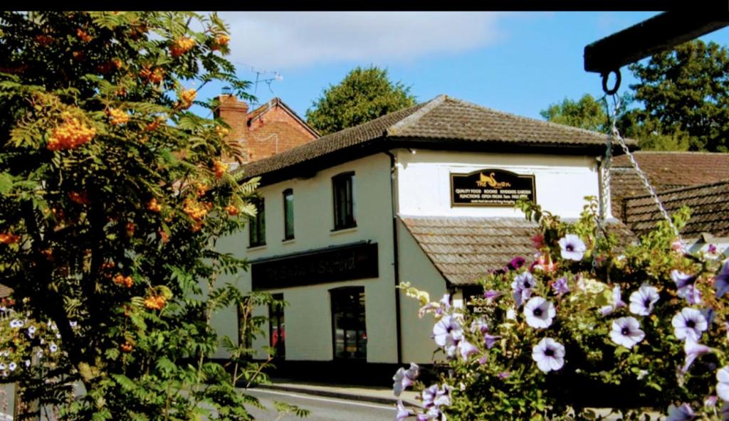 a white building with flowers in front of it at the swan stoford in Salisbury