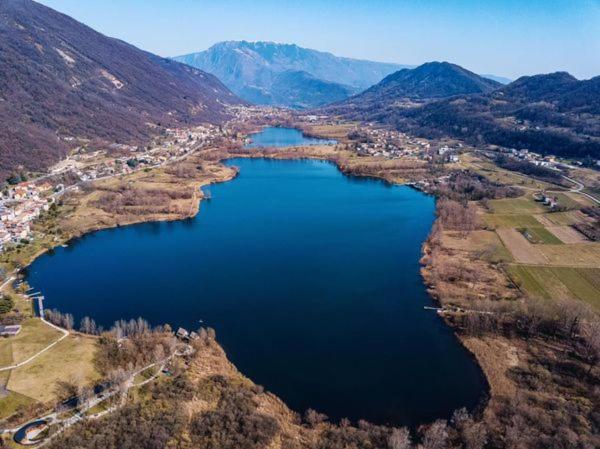 an aerial view of a large lake in the mountains at House in The Calm Nature of Prosecco Valley in Revine Lago