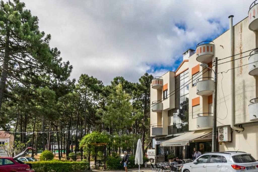 a white car parked in front of a building at Beach, surf and golf apartment near Lisbon in Aroeira