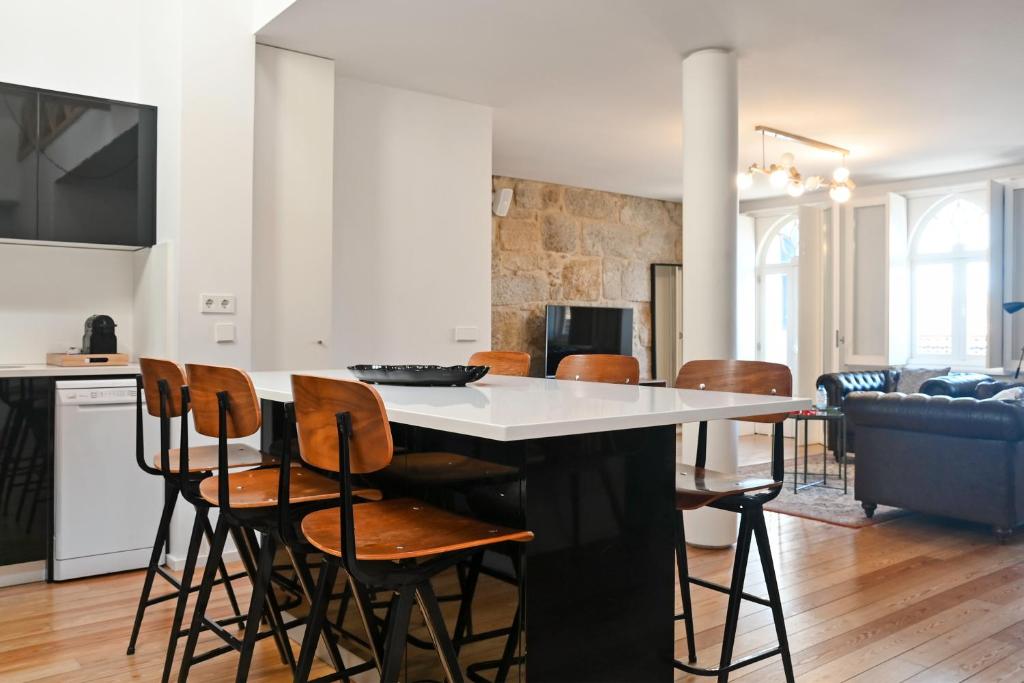 a kitchen and living room with a table and chairs at Oporto Chic&Cozy - Ribeira in Porto