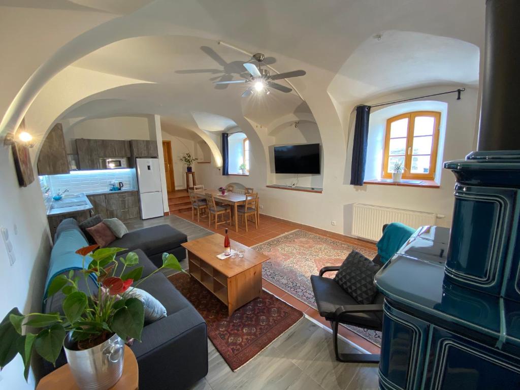 a living room with a couch and a table at Apartment Mařenka Frymburk in Frymburk