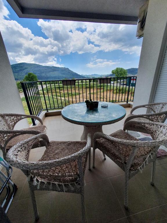 a table and chairs on a balcony with a view at Sunshine in Trebinje