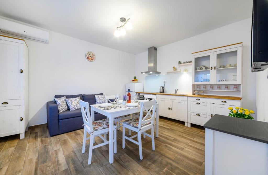 a kitchen and living room with a table and chairs at Apartman Slavko in Šibenik