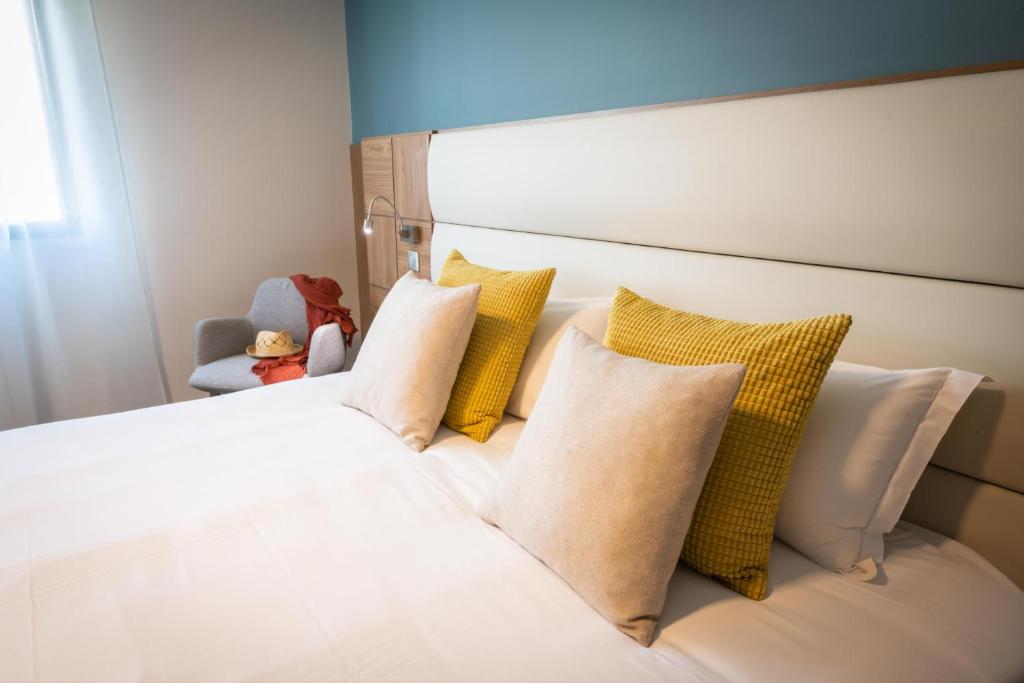 Postel nebo postele na pokoji v ubytování Hotel Port Toga