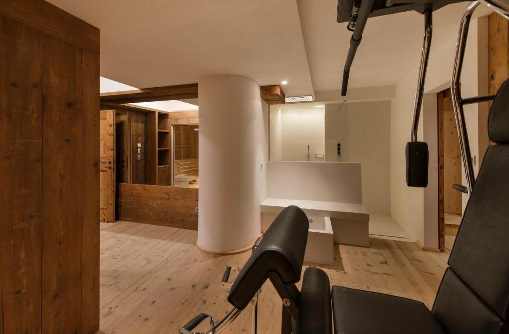 a room with a gym with a chair in a room at Luxury Cortina in Cortina dʼAmpezzo
