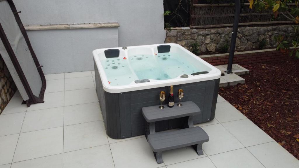 a jacuzzi tub sitting on a patio at Holiday Home Relax - Mošćenička Draga in Mošćenička Draga