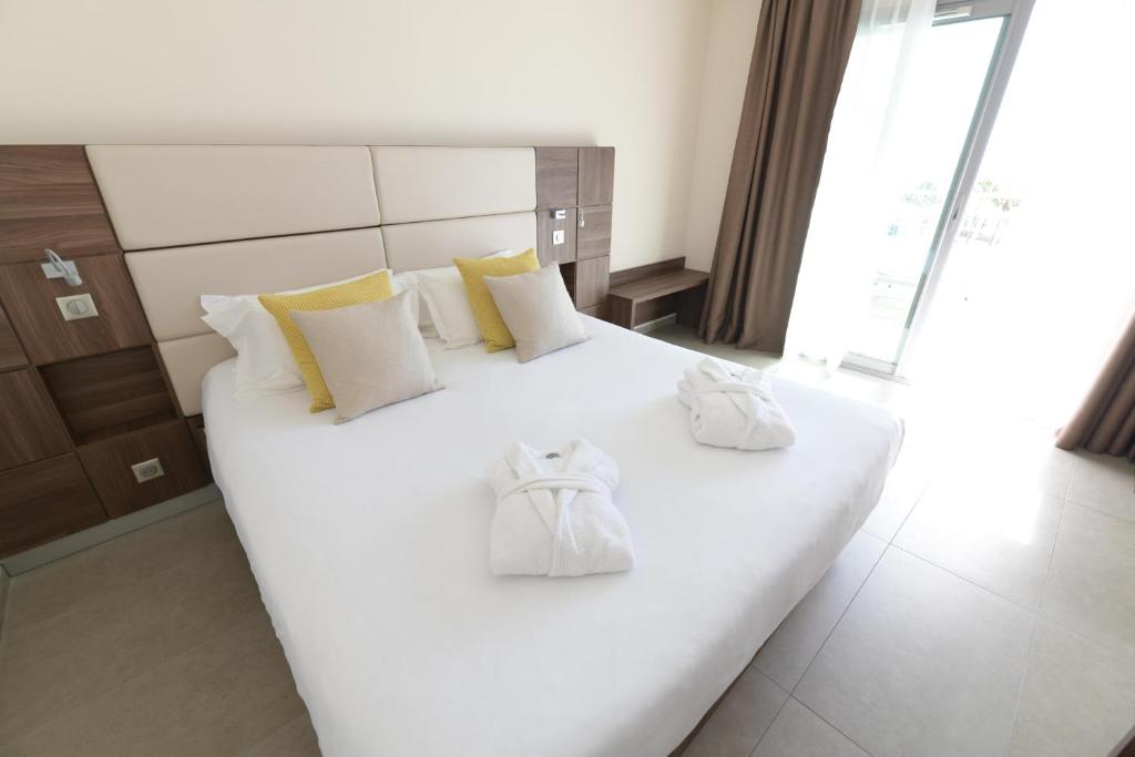 Postel nebo postele na pokoji v ubytování Hotel Port Toga