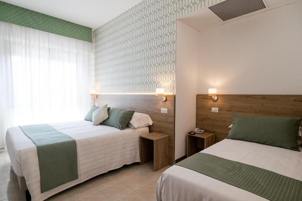 Postel nebo postele na pokoji v ubytování Hotel Pacific
