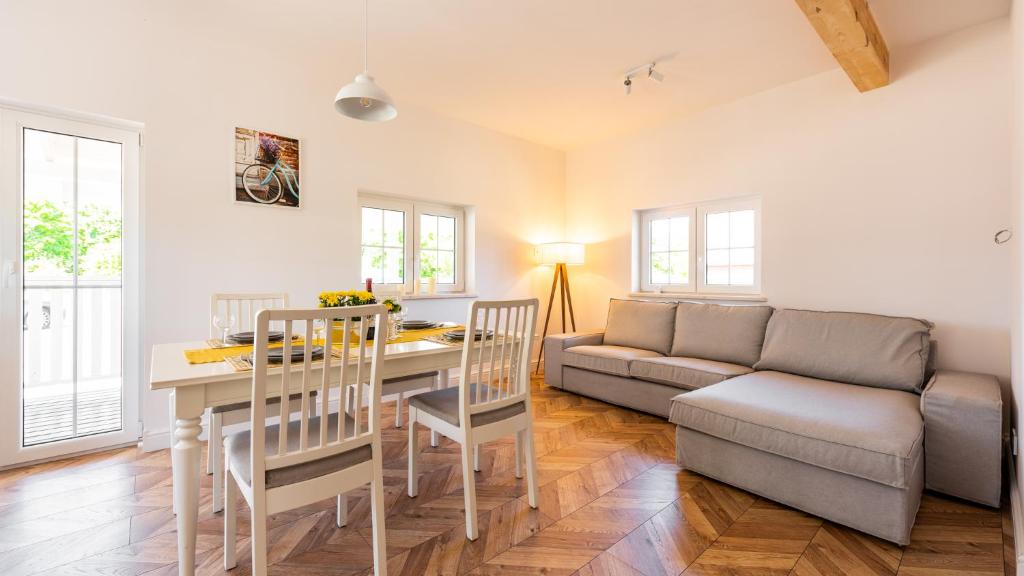 a living room with a table and a couch at Domek Magda in Gdańsk