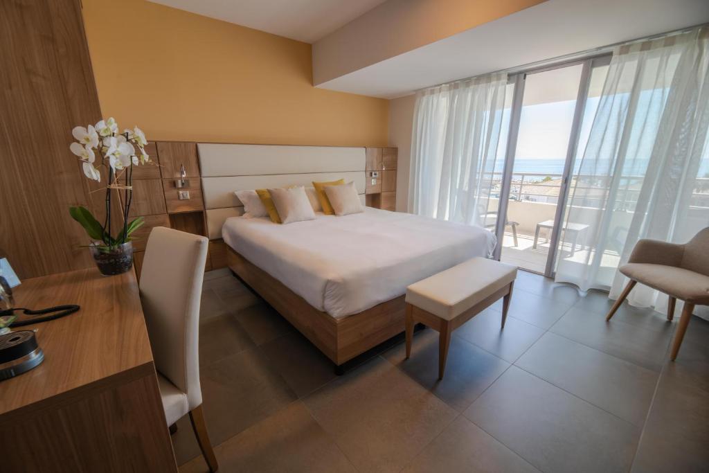 Postel nebo postele na pokoji v ubytování Hotel Port Toga