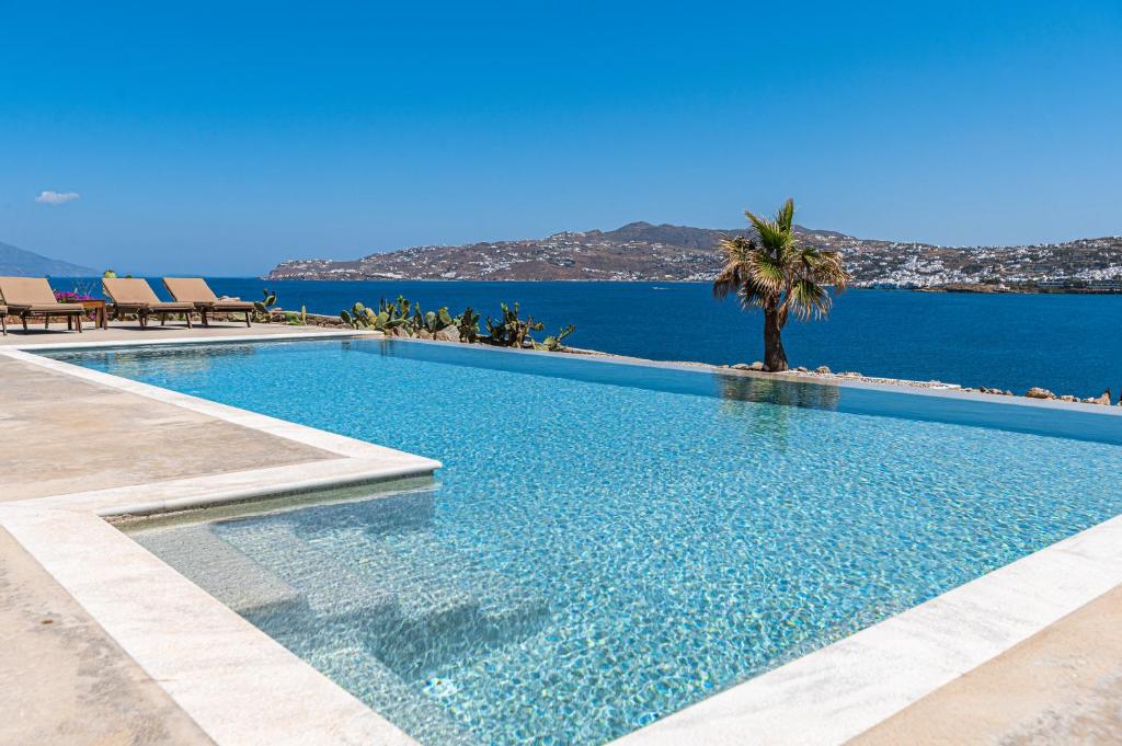 a swimming pool with a view of the ocean at Carpe Diem Villas Mykonos ,Heated Pool! in Ornos