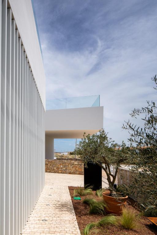 a building with a white wall and a courtyard at Hotel Porfirio Picota - Adults Recommended in Zahara de los Atunes