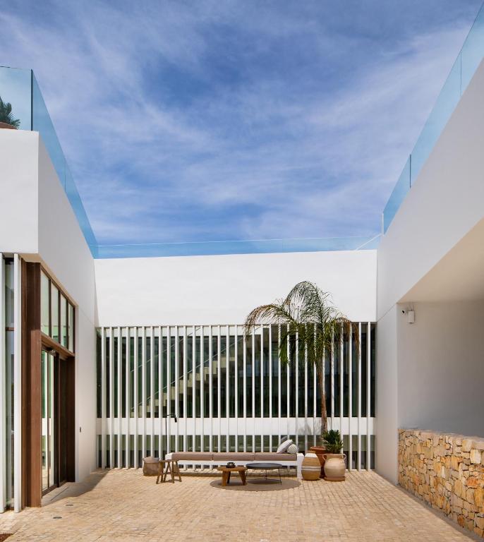 a room with a bench and a large window at Hotel Porfirio Picota - Adults Recommended in Zahara de los Atunes