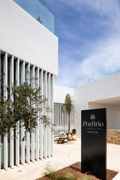 a white building with a sign in front of it at Hotel Porfirio Picota - Adults Recommended in Zahara de los Atunes