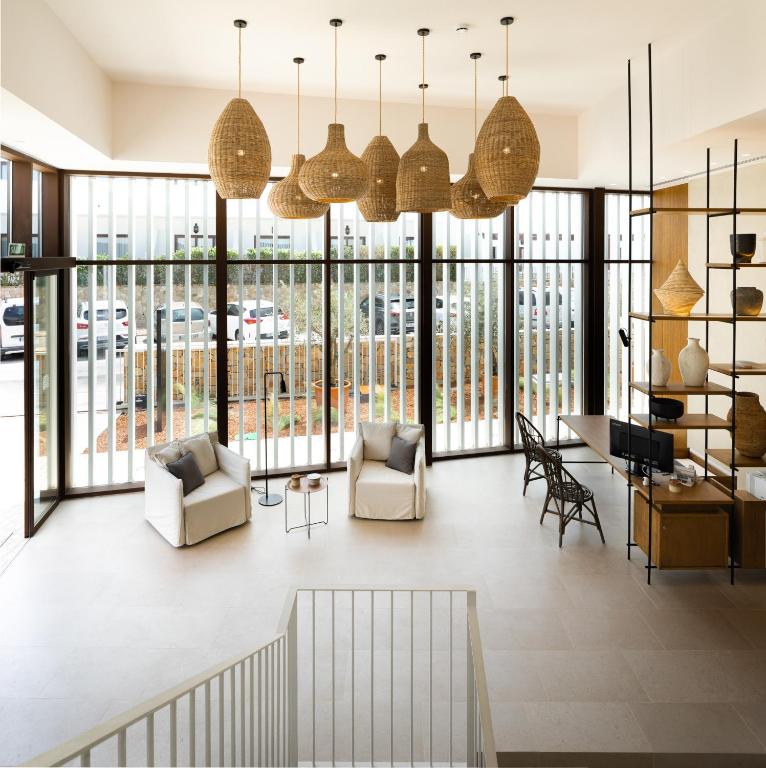 a living room with large windows and chairs at Hotel Porfirio Picota - Adults Recommended in Zahara de los Atunes