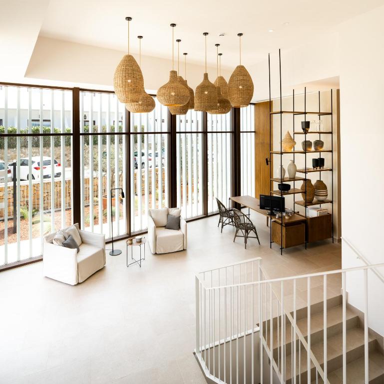 a living room with large windows and a dining room at Hotel Porfirio Picota - Adults Recommended in Zahara de los Atunes