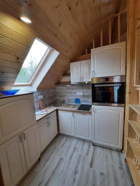 a kitchen with white cabinets and a window at Villa M in Vinci