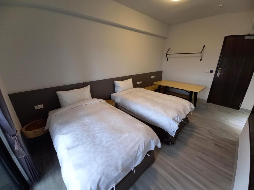 Postel nebo postele na pokoji v ubytování 航空棧輕旅民宿