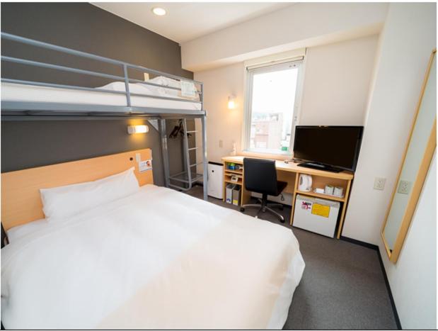 Postel nebo postele na pokoji v ubytování Super Hotel Yonago Ekimae