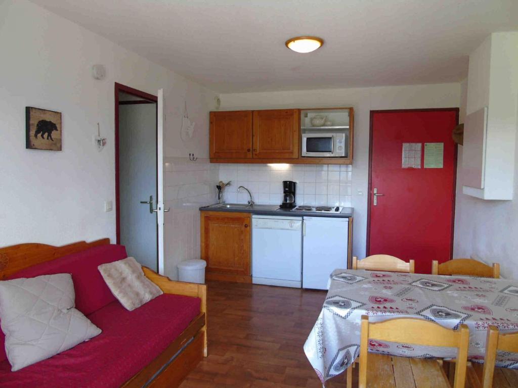 eine Küche und ein Wohnzimmer mit einem Sofa und einem Tisch in der Unterkunft Appartement Valfréjus, 2 pièces, 4 personnes - FR-1-561-49 in Modane