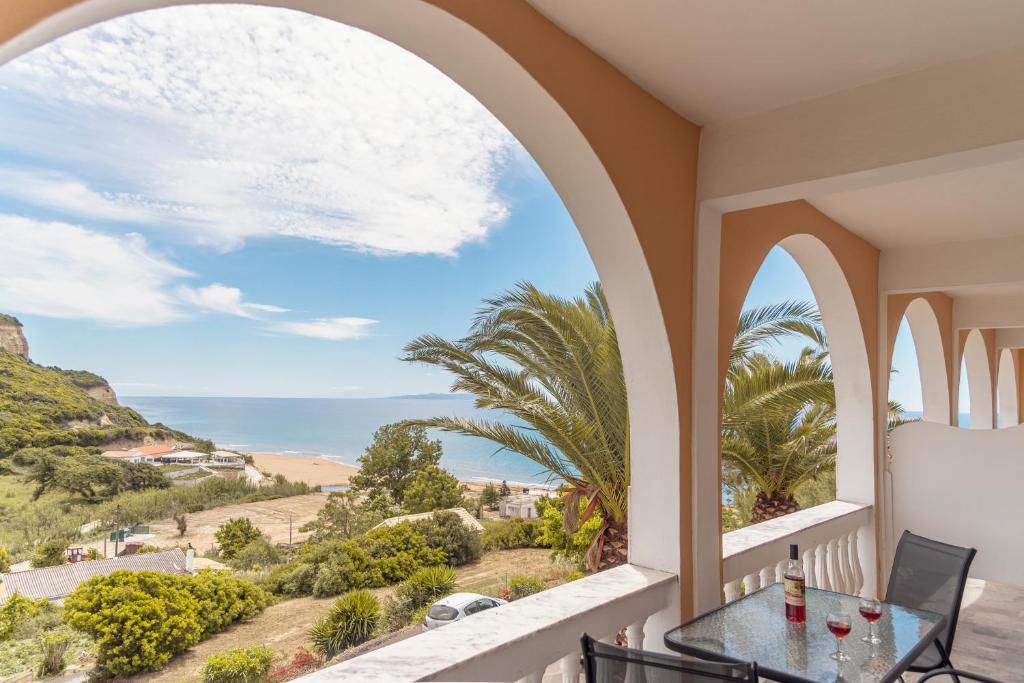 a balcony with a table and a view of the ocean at Adriatica View in Vitalades