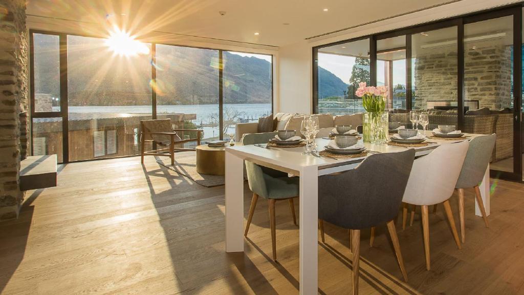 a dining room with a white table and chairs at Marina Terrace, Wanaka in Wanaka