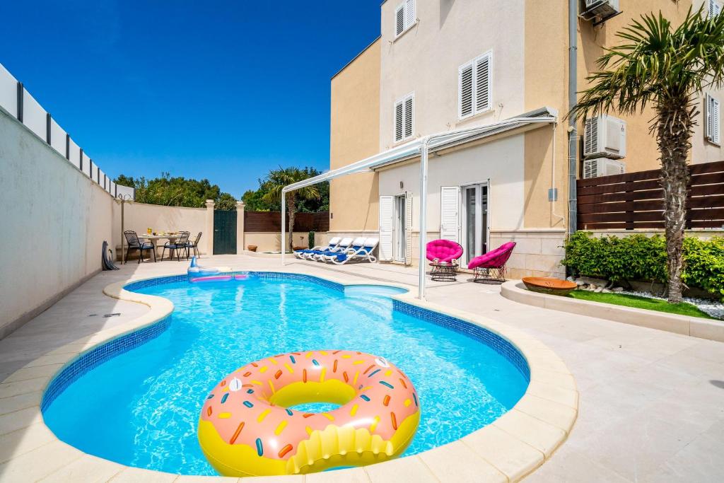 a swimming pool with a donut in the middle at Lorena Suite with private pool in Dubrovnik