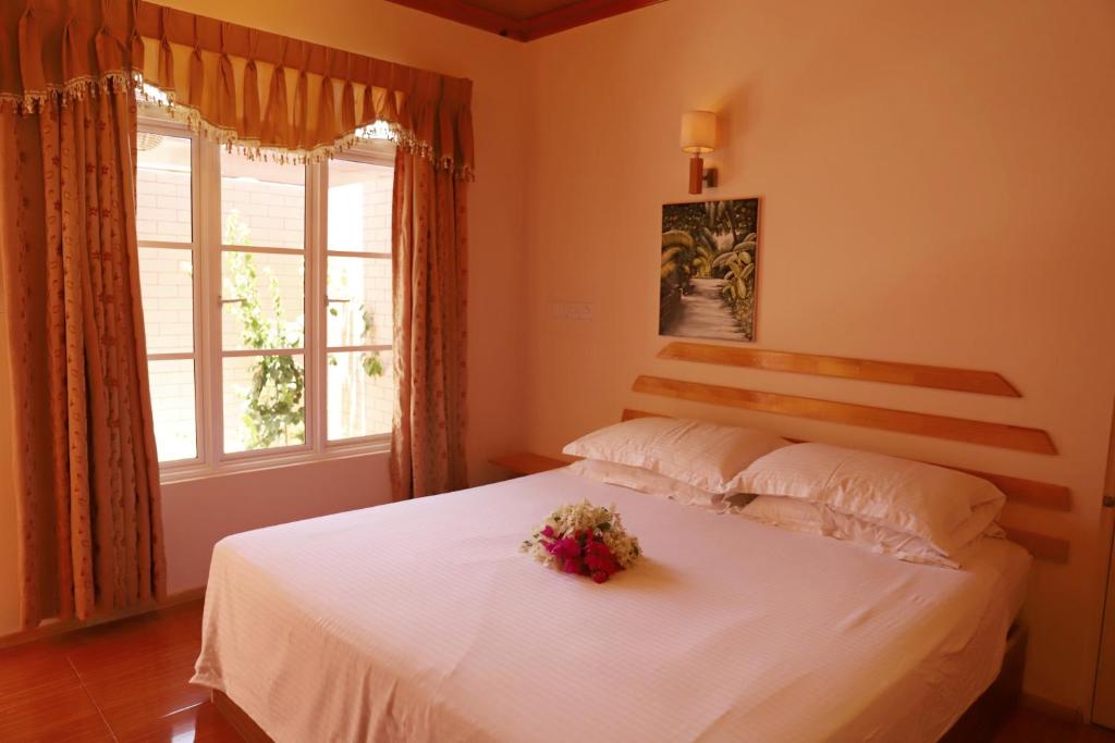 Postel nebo postele na pokoji v ubytování New Breeze Thoddoo Inn
