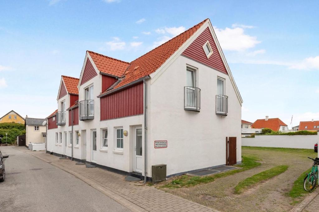 a row of houses with red roofs on a street at Løkken centrum ferielejlighed-apartment 4F in Løkken
