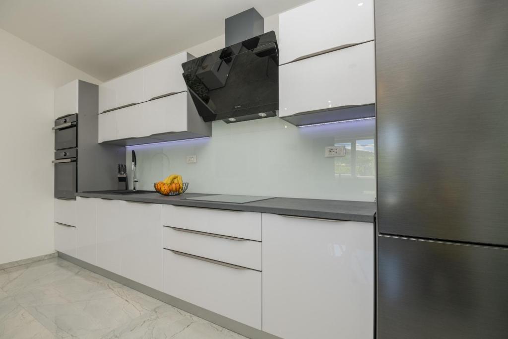 Kuchyň nebo kuchyňský kout v ubytování Holiday Home Maslina