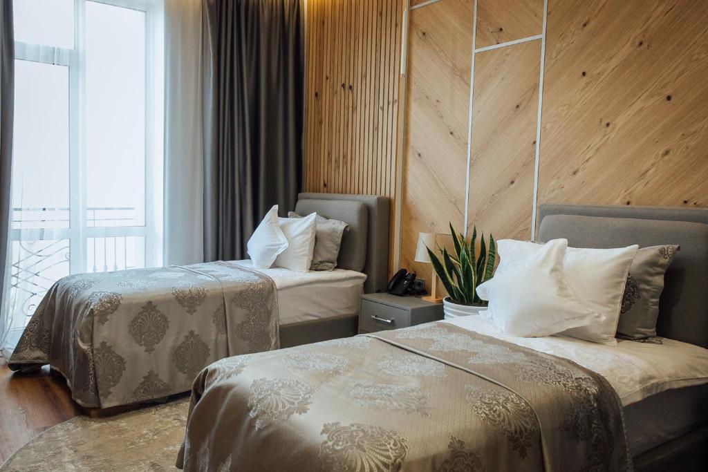 Postel nebo postele na pokoji v ubytování Alice Place Hotel