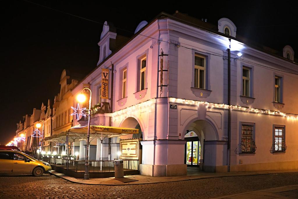 un edificio en una calle de la ciudad por la noche en Hotel Zlatá Včela en Domažlice