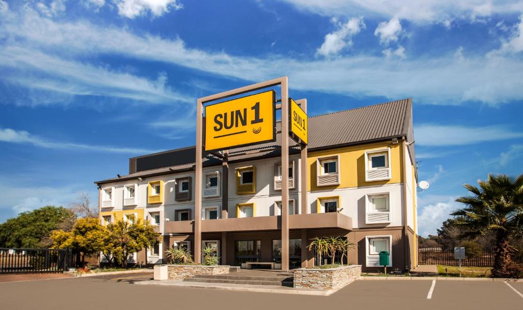 a yellow building with a sign in front of it at SUN1 Vereeniging in Vereeniging