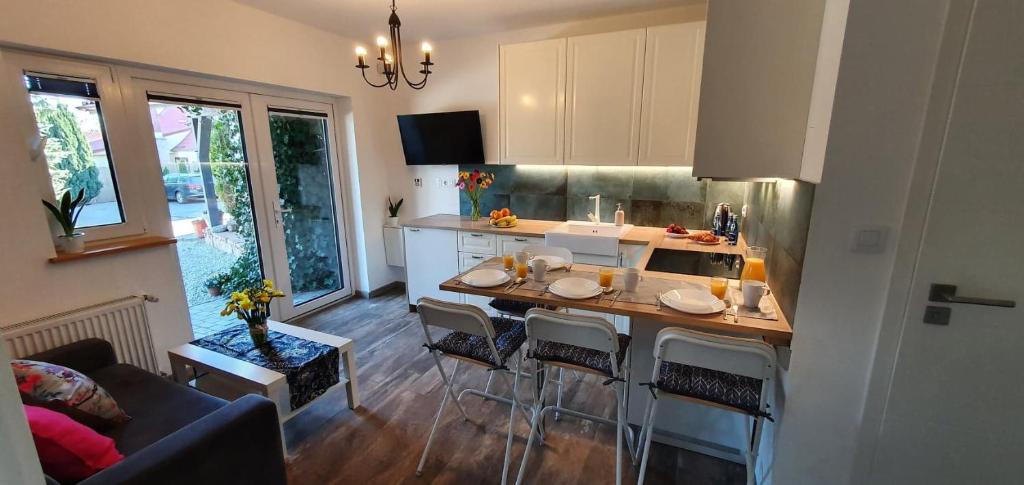 a kitchen with a island with bar stools at Kamień Bałtyku Apartament in Debina