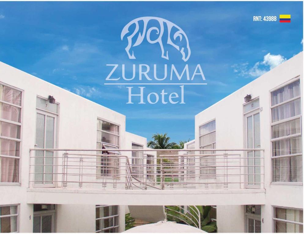 a sign for a zuriulum hotel on top of a building at Zuruma Hotel in Leticia