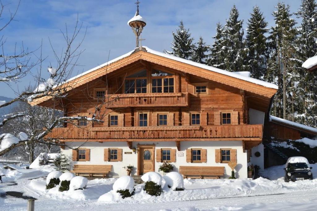 a log cabin in the snow with snow covered at Wegrainhof in Kirchberg in Tirol