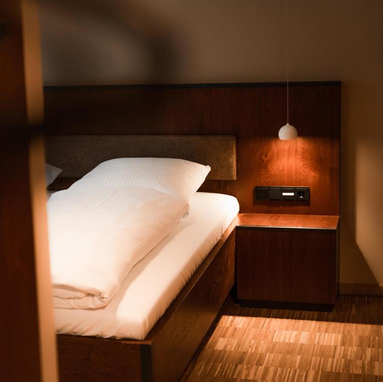 a bedroom with a bed with a wooden head board at Cavallestro Deluxe in Kitzingen