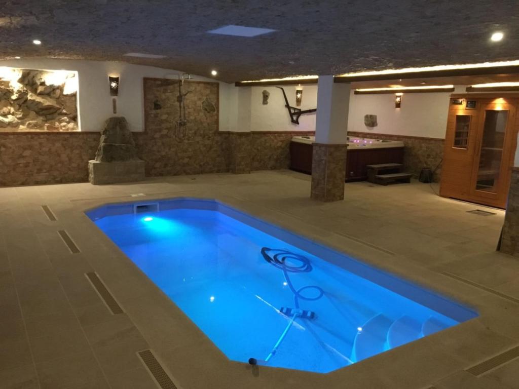 a large swimming pool in a large room at CASA CORRALON in Grazalema