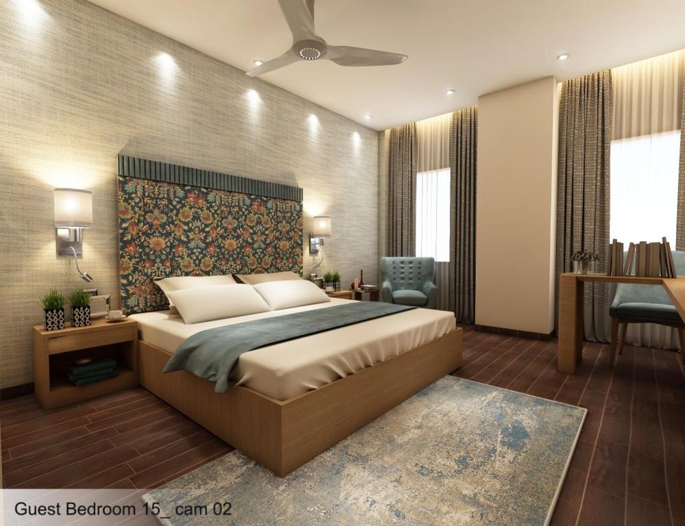 a bedroom with a bed and a desk and a chair at THE PEARL in Jamshedpur