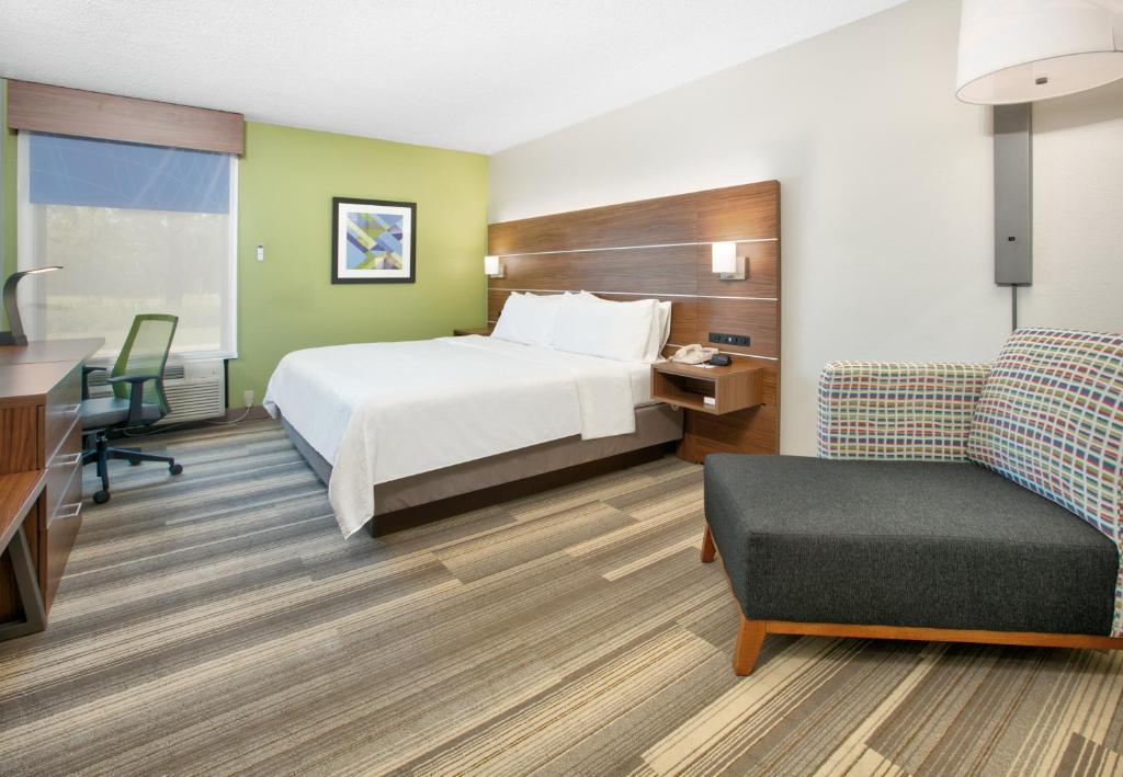 a hotel room with a bed and a desk and a chair at Holiday Inn Express - Hope by IHG in Hope