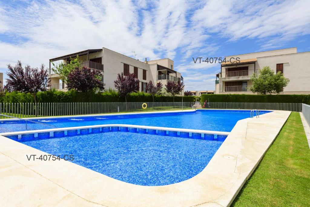 a swimming pool in front of a building at Apartamento en Residencial Aldea Golf Panorámica in San Jorge