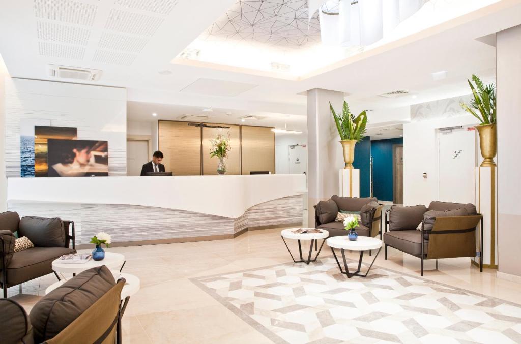 a lobby of a hotel with couches and tables at Residhome Marseille in Marseille